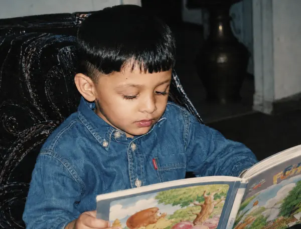 Ali as a boy, reading